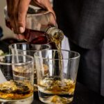 Best Bourbon for Mint Julep: How to Pick the Right Bottle and Batch It Right person pouring brown liquid on clear drinking glass