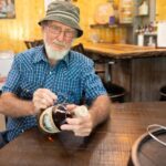 Neeley Family Distillery Introduces Papaw’s Legacy Reserve 10 Year Triple Pot-Stilled Earl “PaPaw” Sizemore signing bottles at Neeley Family Distillery.